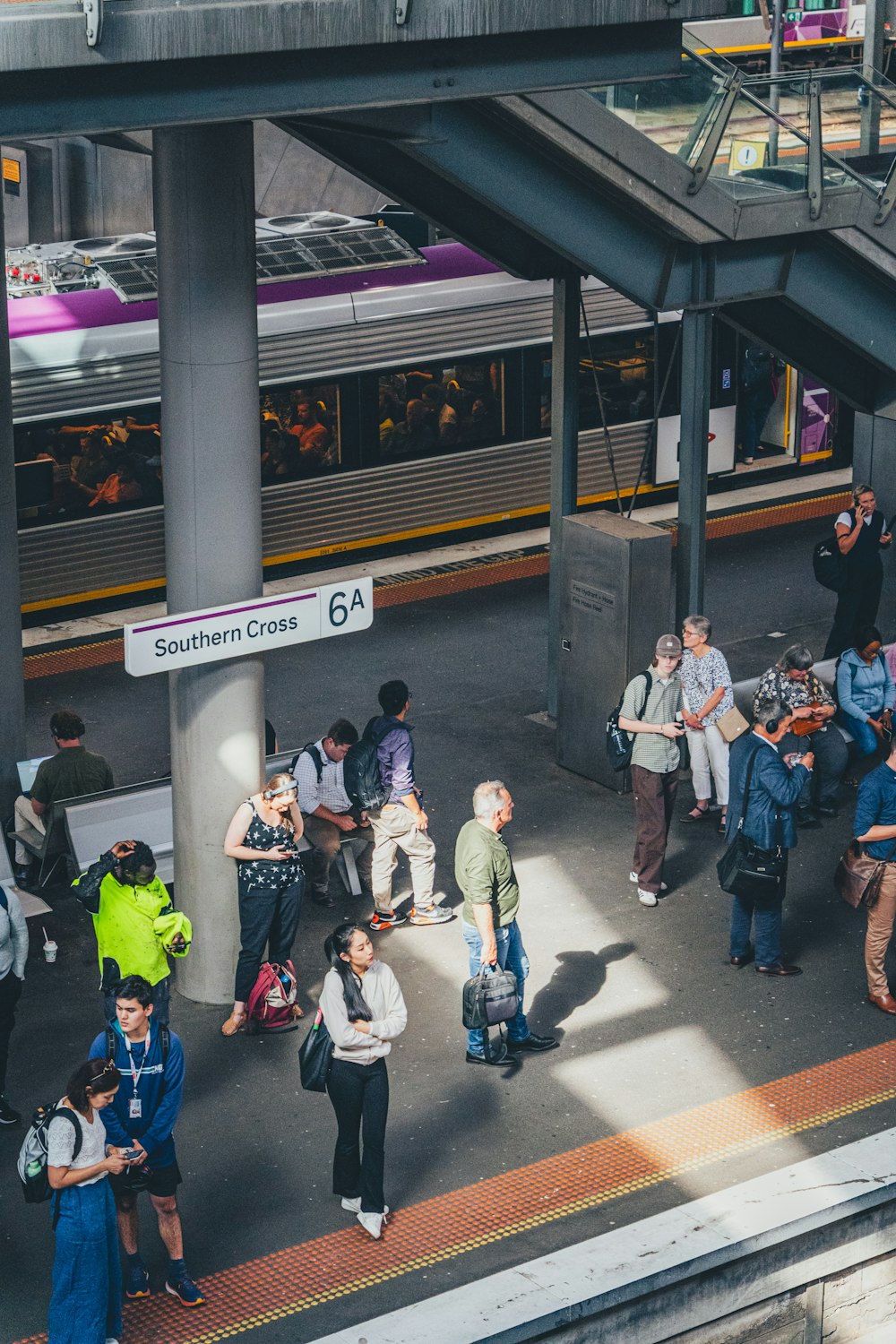 a group of people waiting at a train station