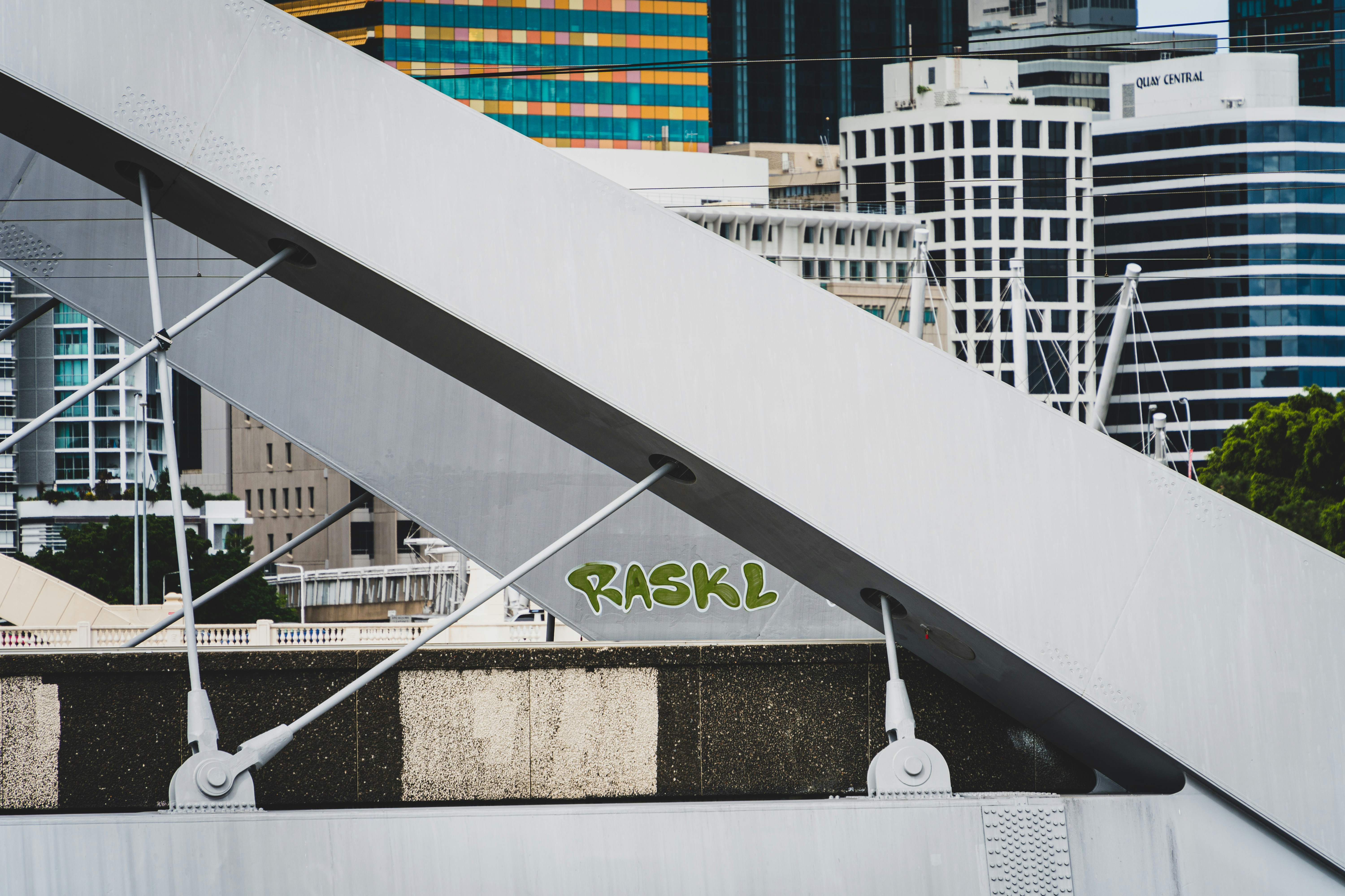 graffiti on the side of a bridge in a city
