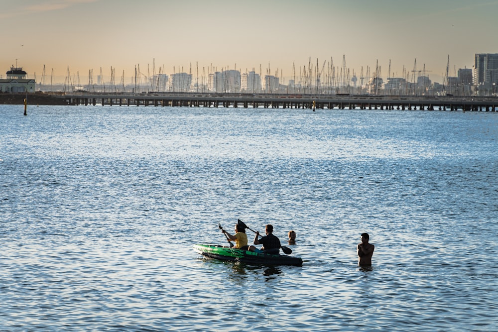 a group of people in a small boat in the water