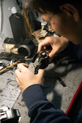 a man is working on a piece of metal