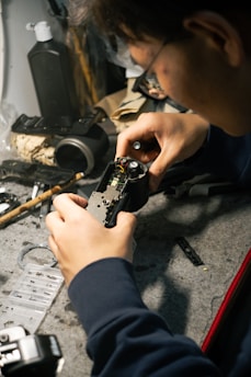 a man is working on a piece of metal