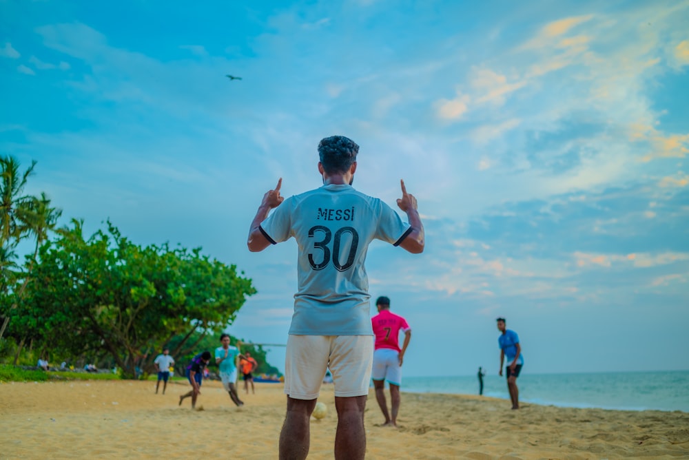 a man standing on top of a sandy beach