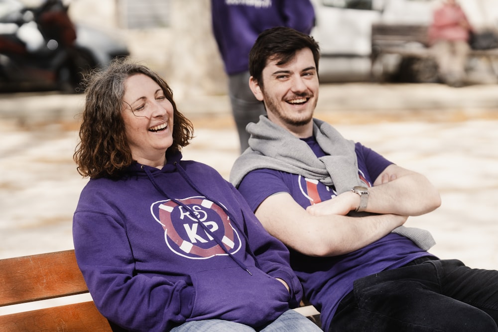 a man and a woman sitting on a bench