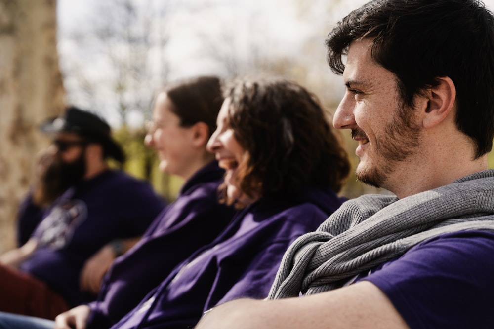 a group of people sitting next to each other