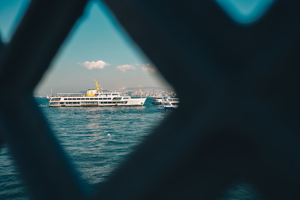 a large white boat in the middle of a body of water