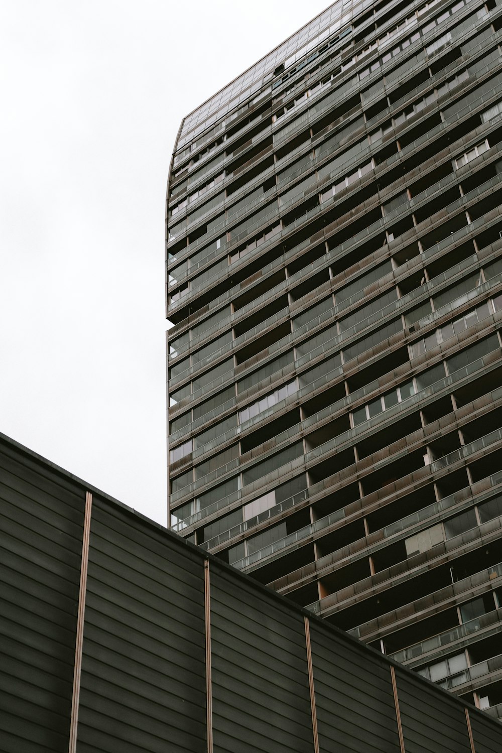 a tall building with lots of windows next to it