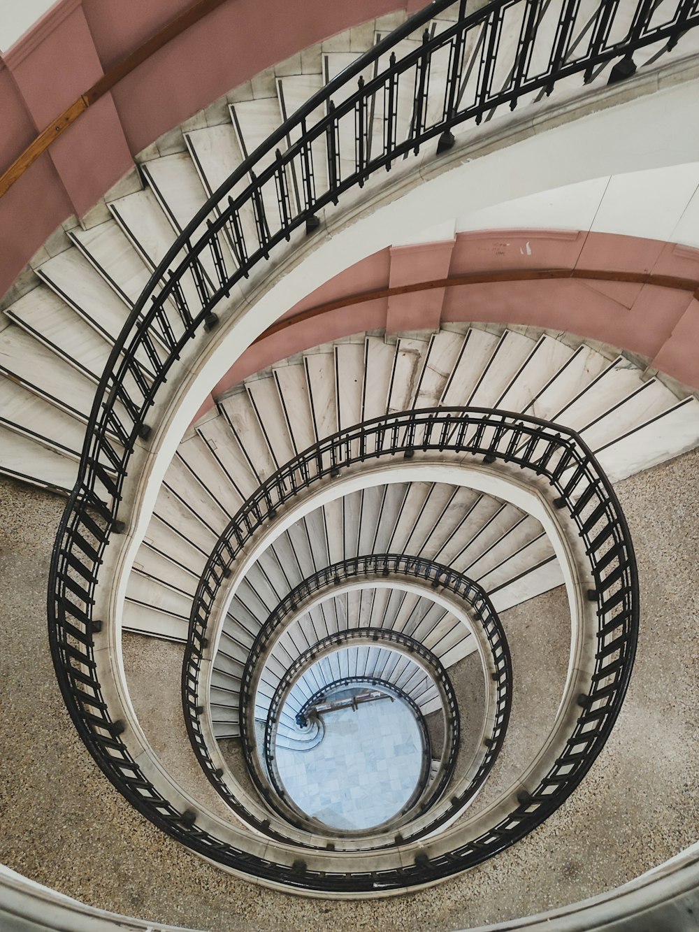 a spiral staircase in a building with metal railings
