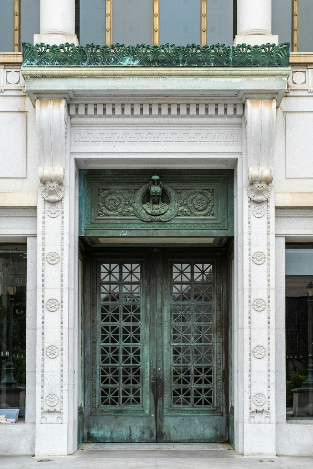 a large green door on the side of a building