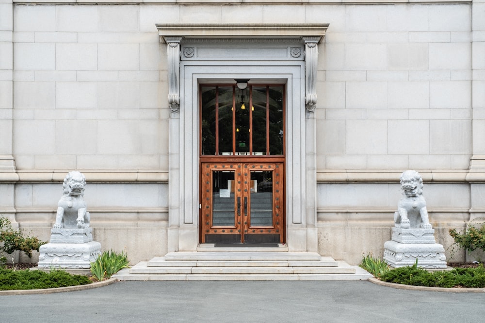 the entrance to a building with statues in front of it