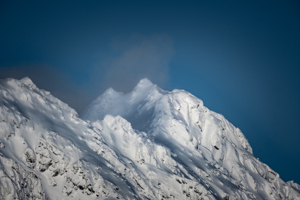 a mountain covered in snow under a blue sky