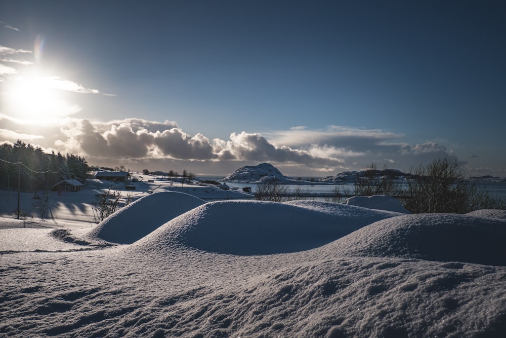 the sun shines brightly over a snowy landscape