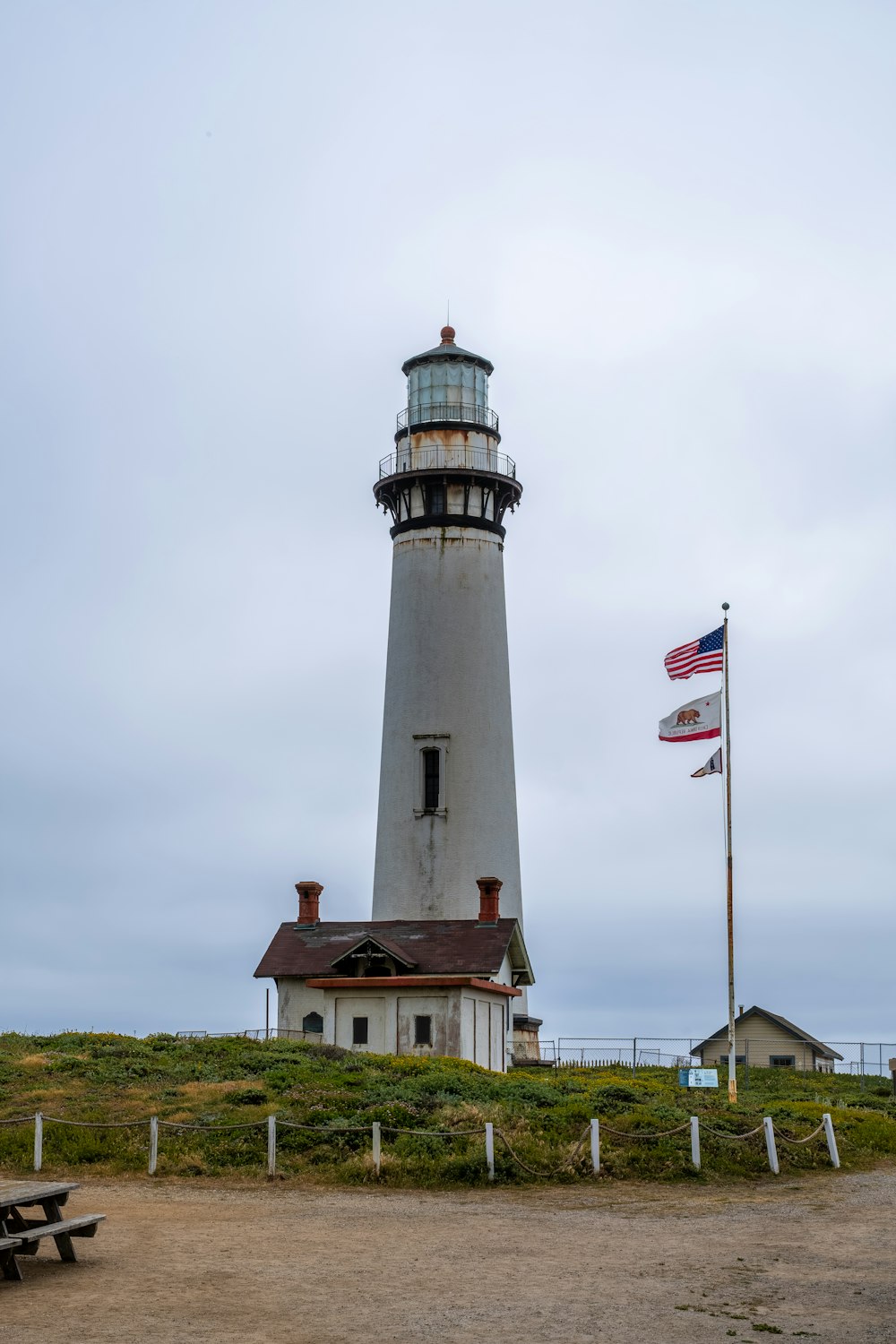 a lighthouse with a flag on top of it