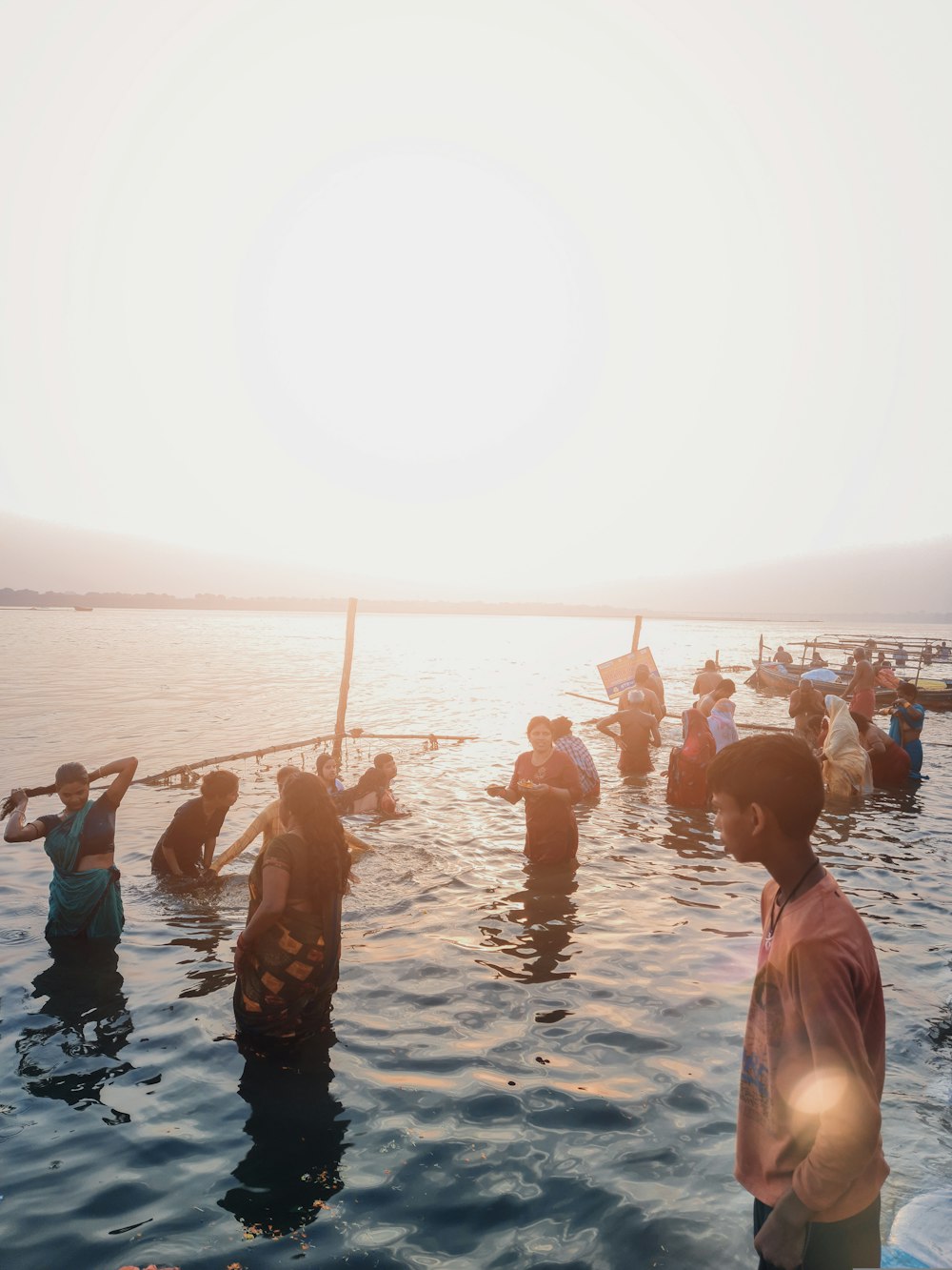 a group of people standing on top of a body of water