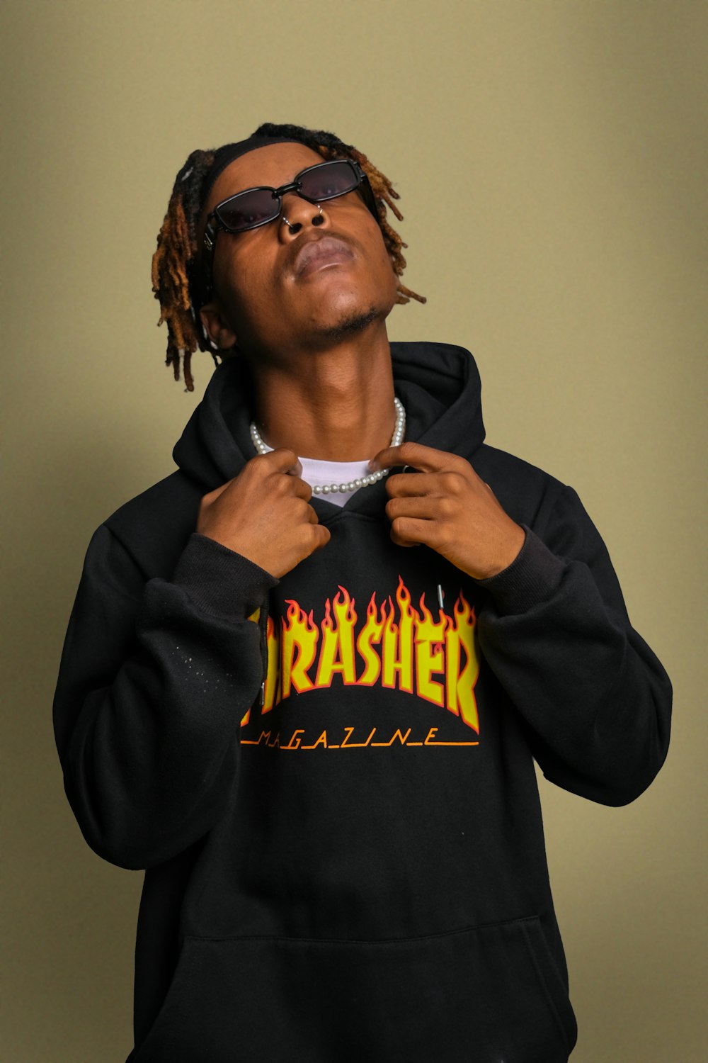 a man wearing a black hoodie with flames on it
