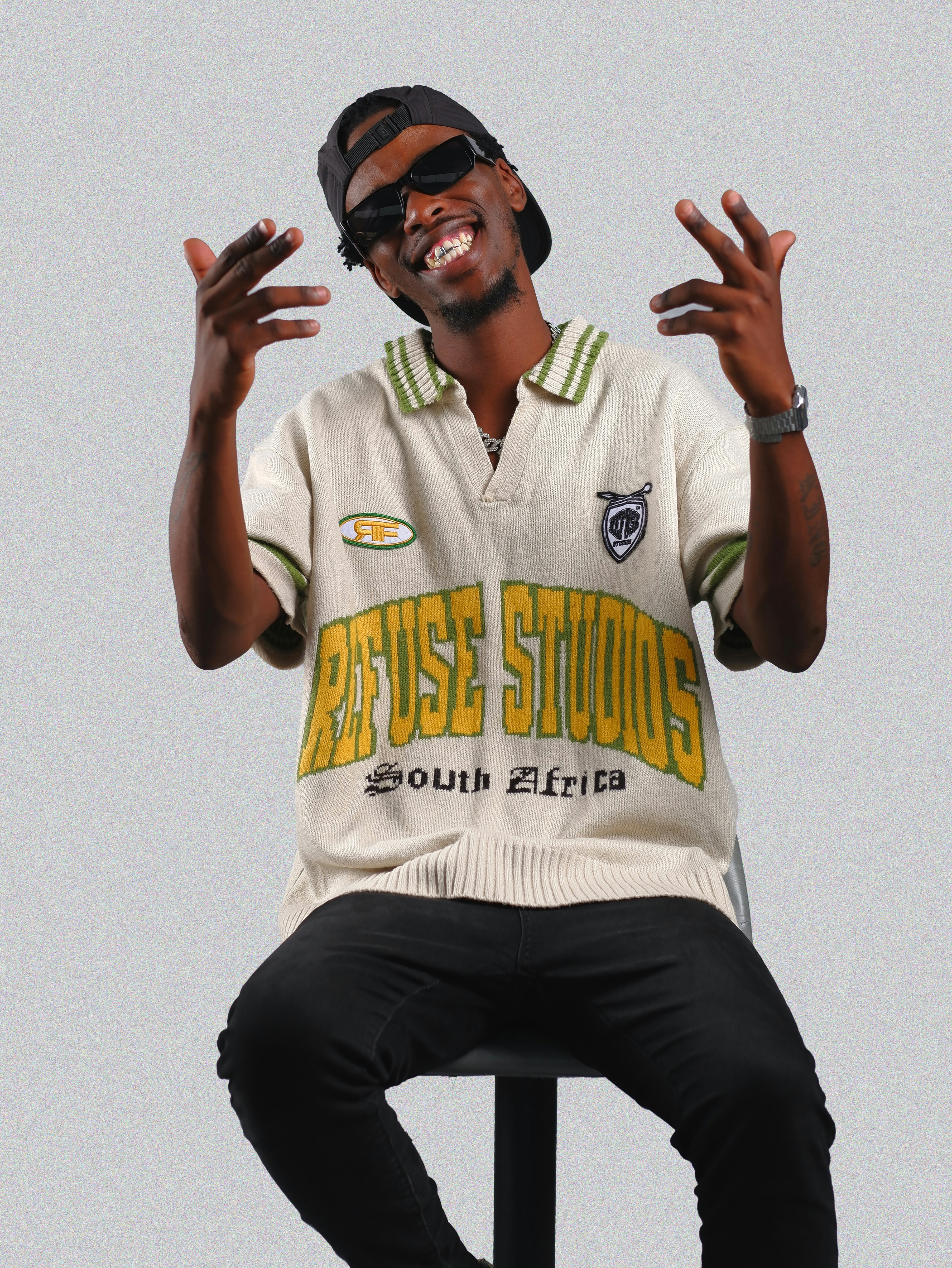 a man sitting on top of a metal pole