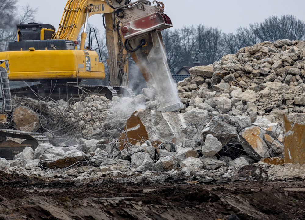 a bulldozer digging through a pile of rubble