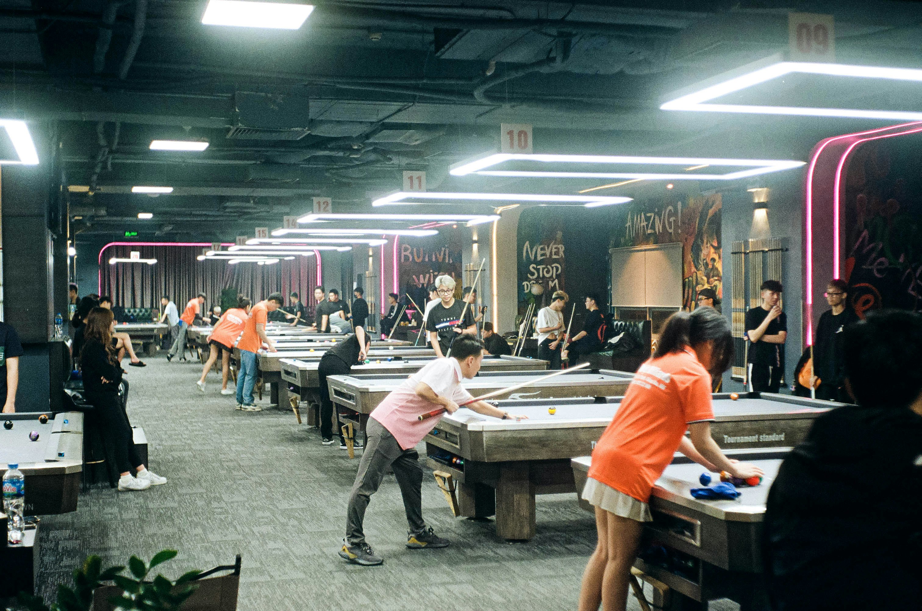 a group of people playing a game of pool