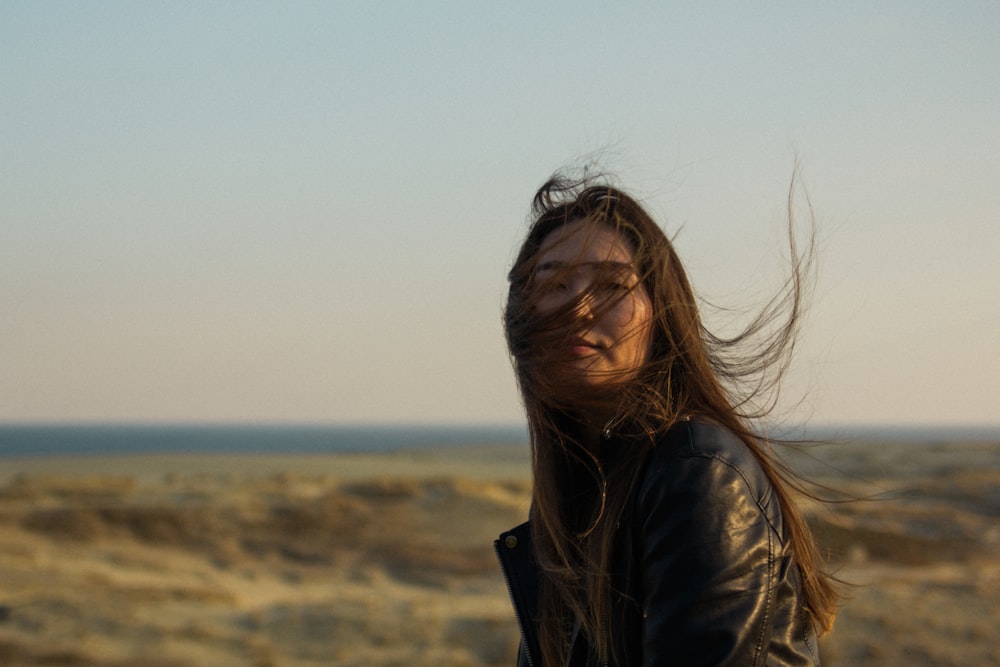 a woman with her hair blowing in the wind