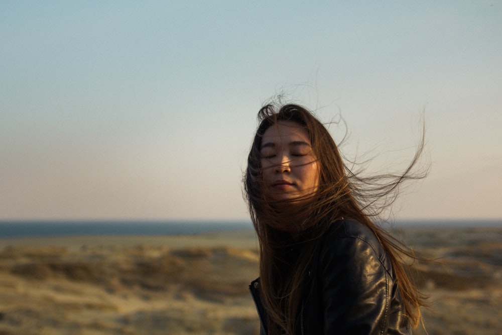 a woman with her hair blowing in the wind