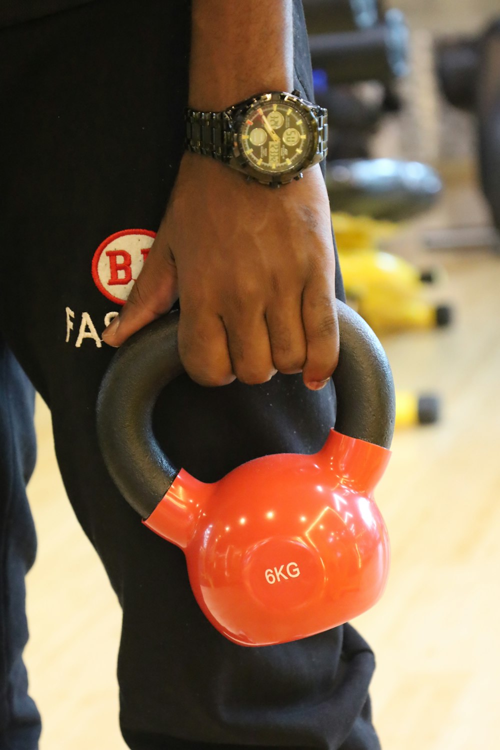 a person holding a kettle with a watch on their wrist