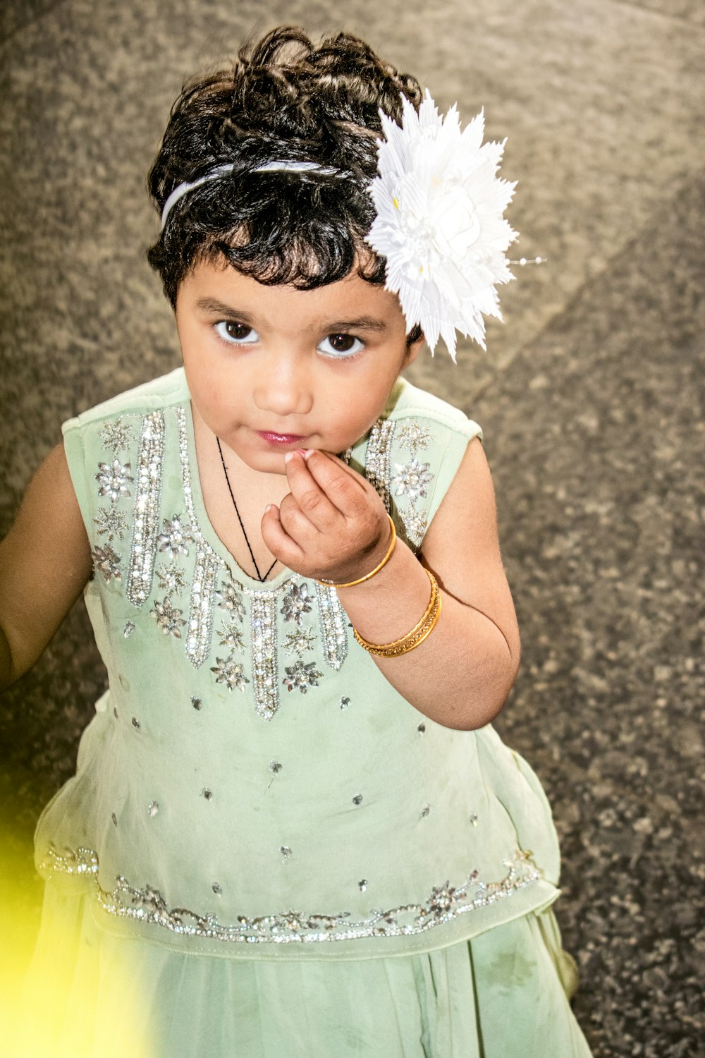 a little girl with a flower in her hair