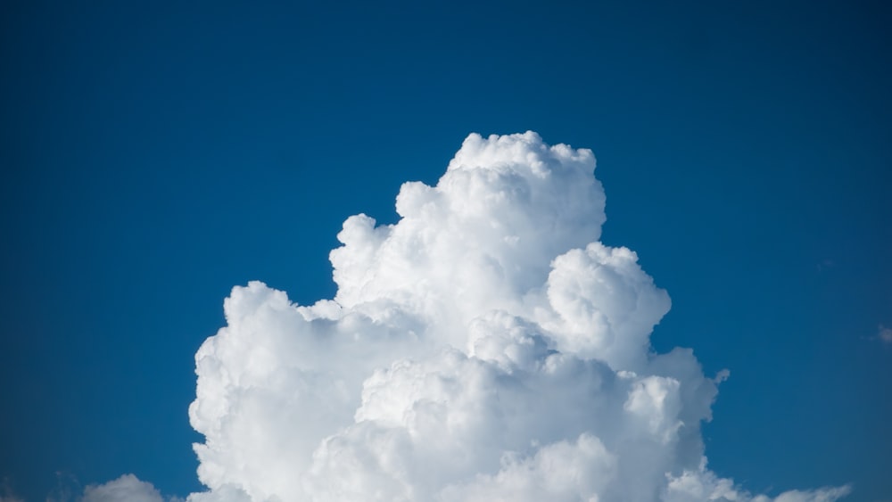 a large cloud in the blue sky