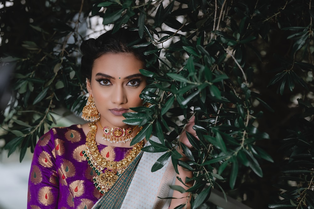 a woman in a purple and green sari