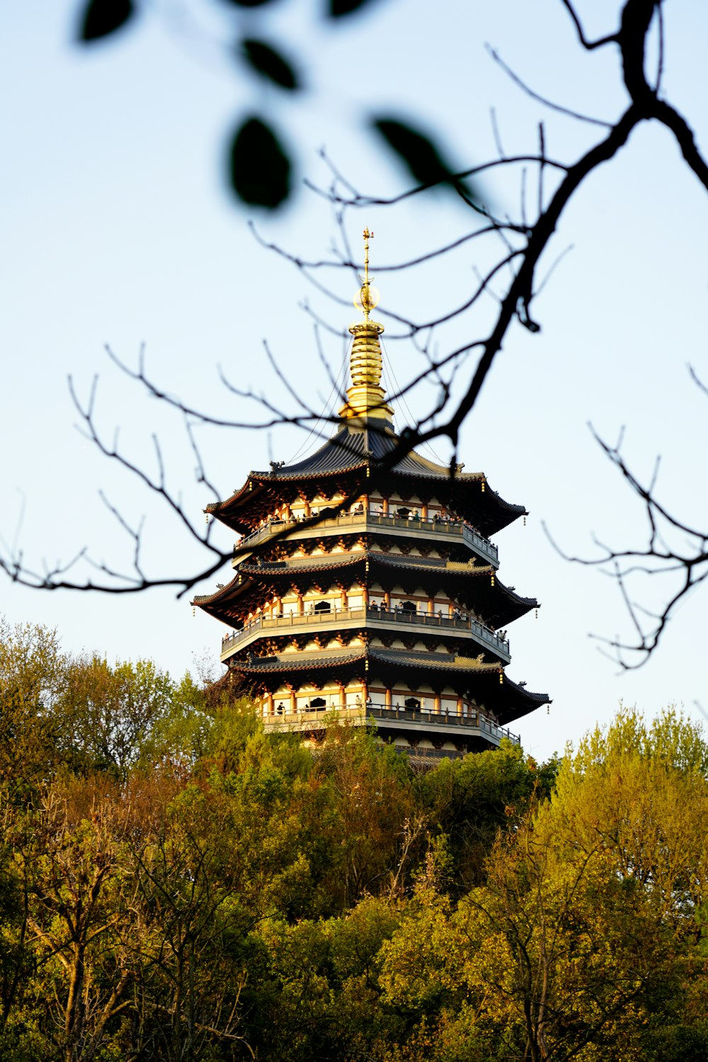 a tall tower sitting on top of a lush green hillside