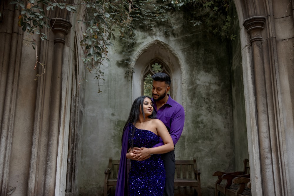 a man and a woman standing in front of a building