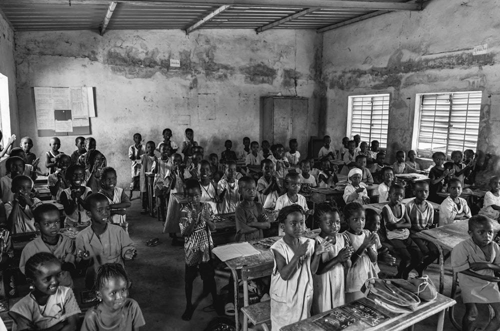 a black and white photo of a classroom full of children