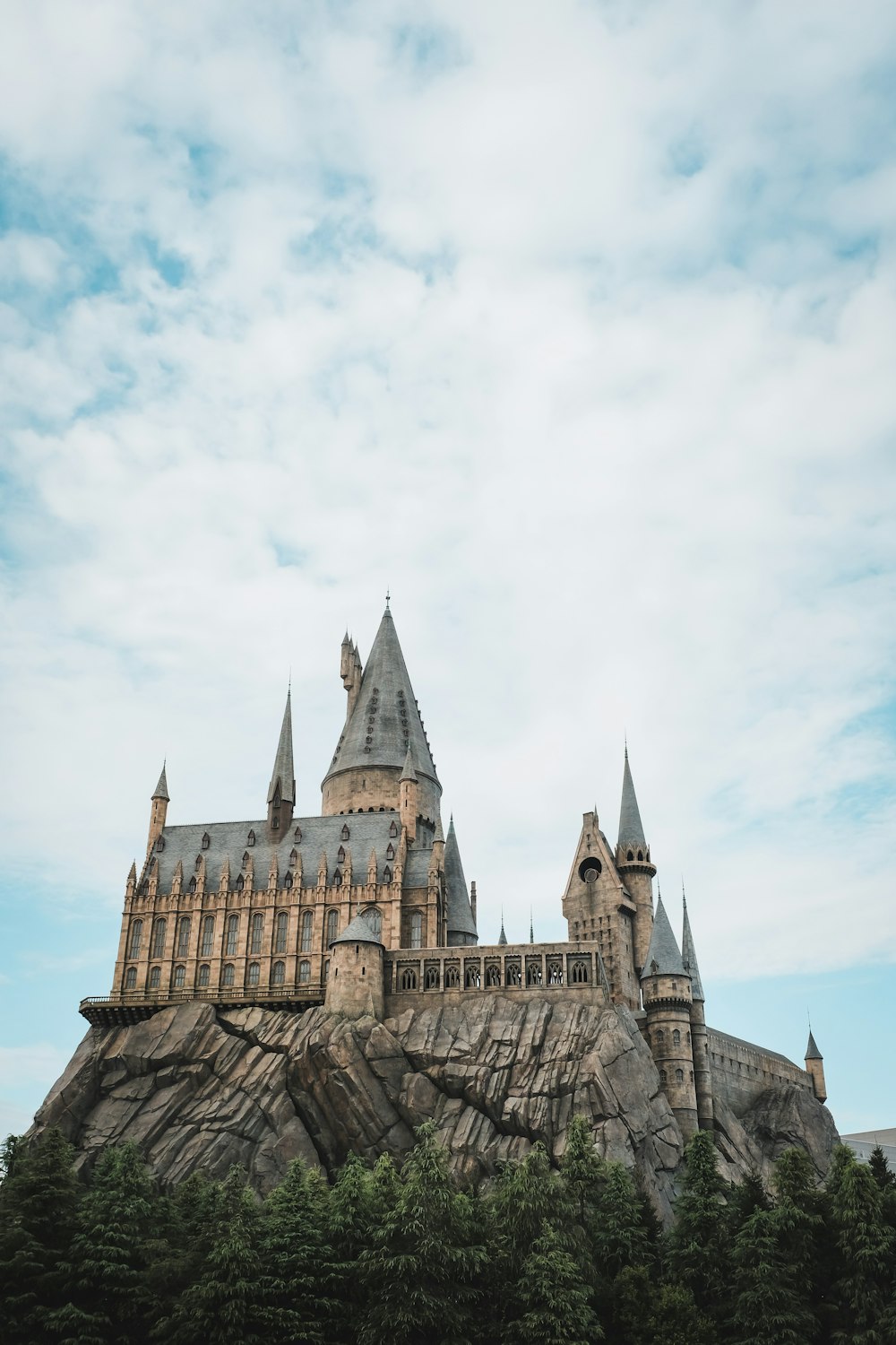 a castle on top of a mountain with a sky background