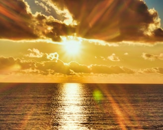 the sun is shining brightly over the ocean