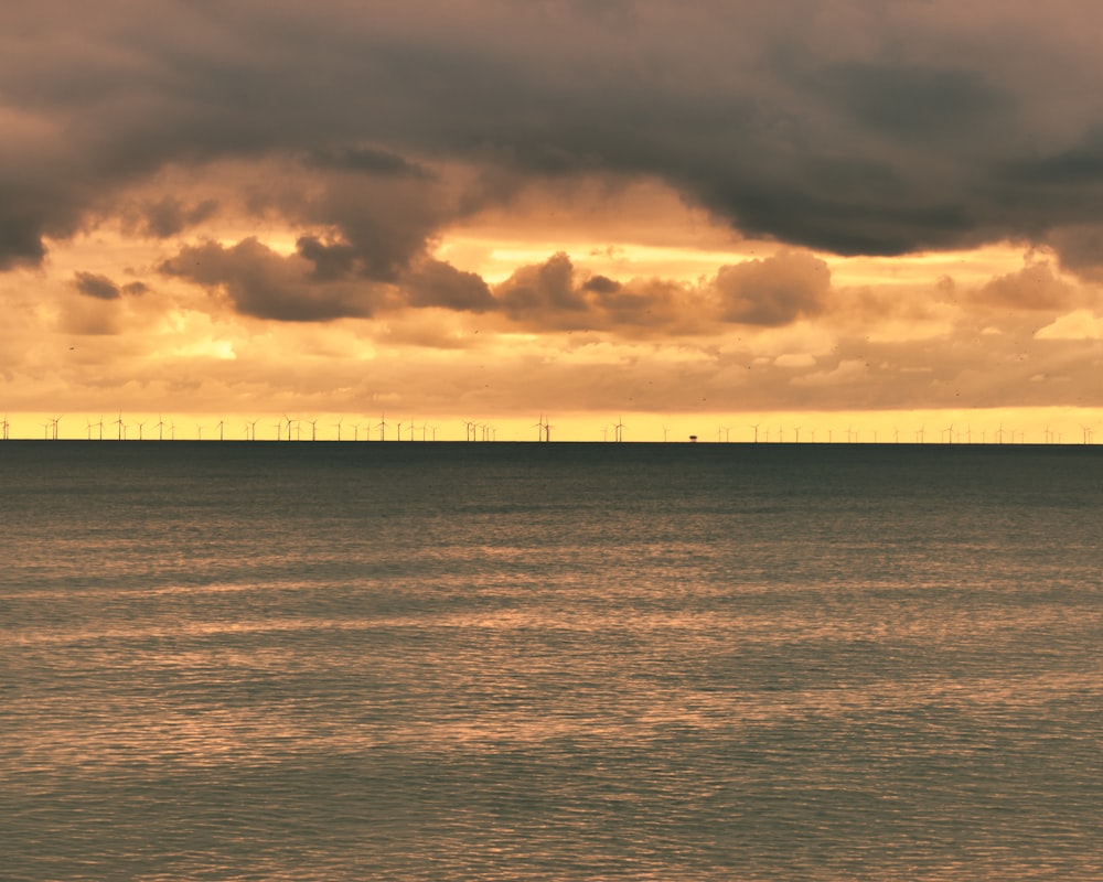 a large body of water under a cloudy sky