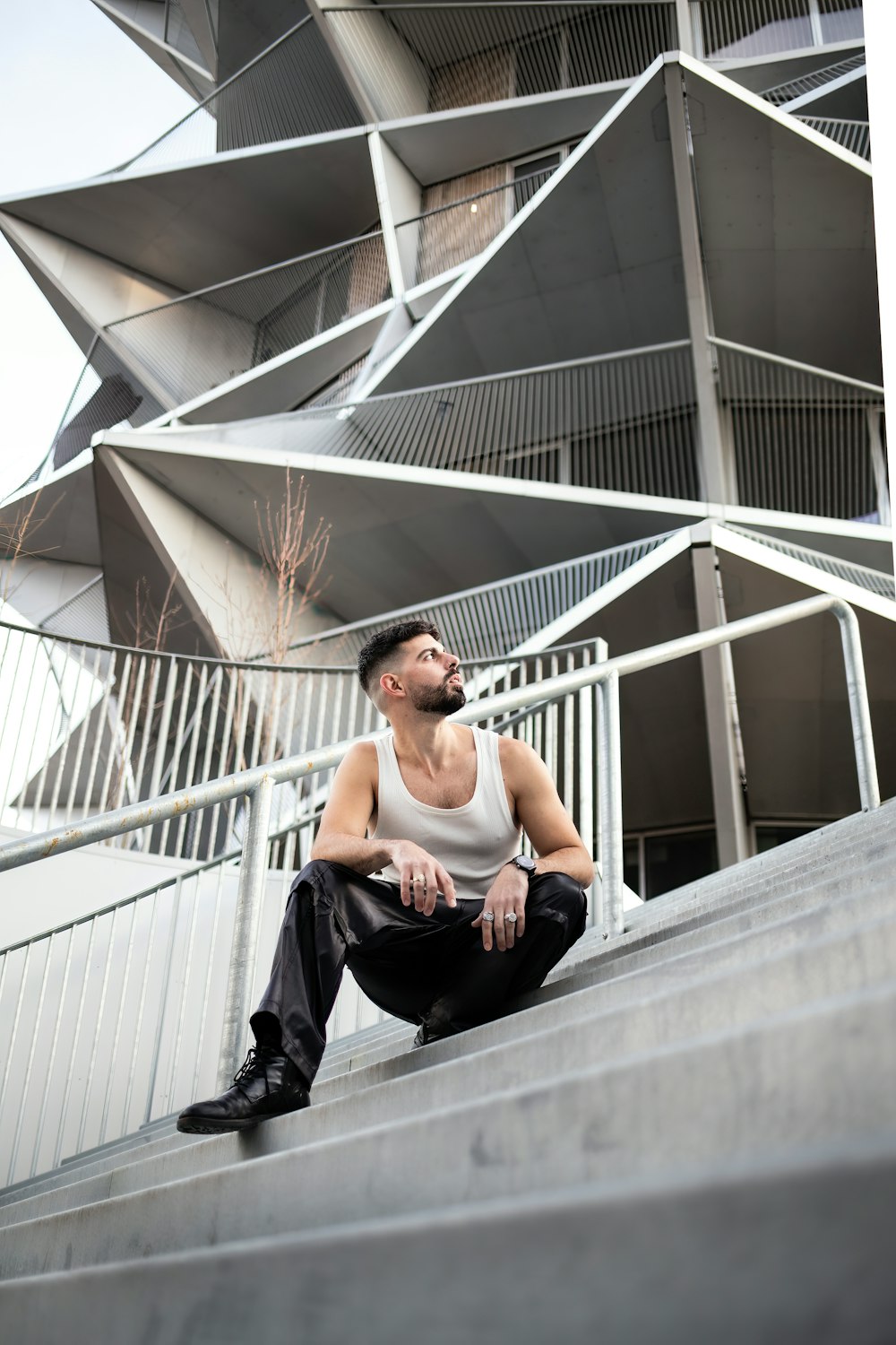 a man sitting on the steps of a building