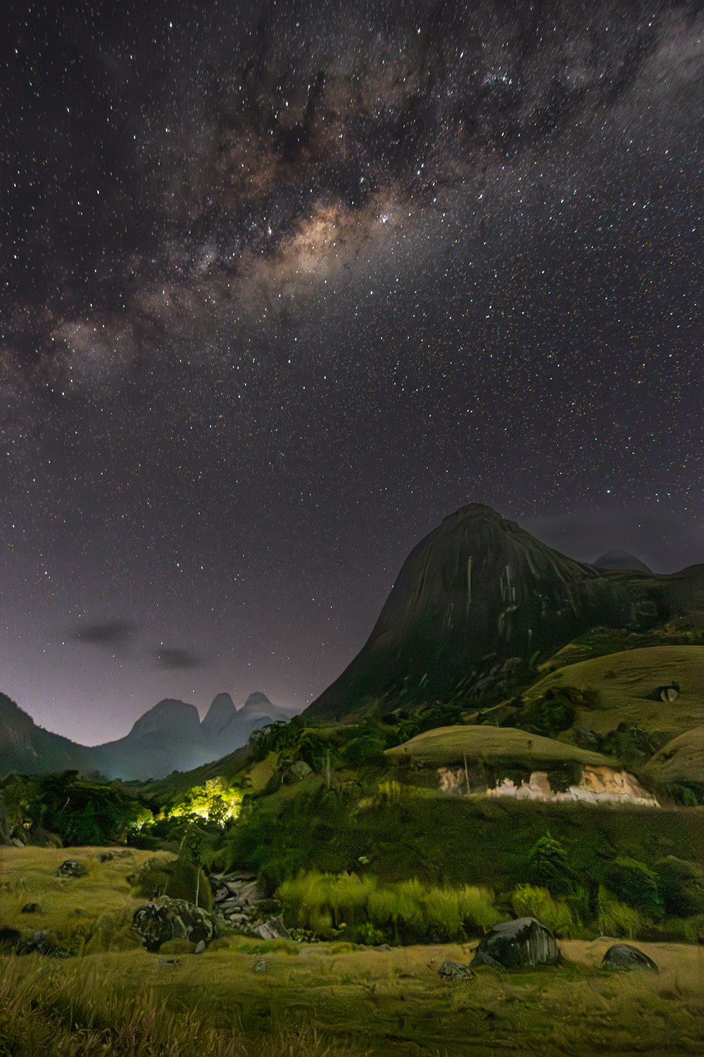 the night sky is filled with stars above a mountain range