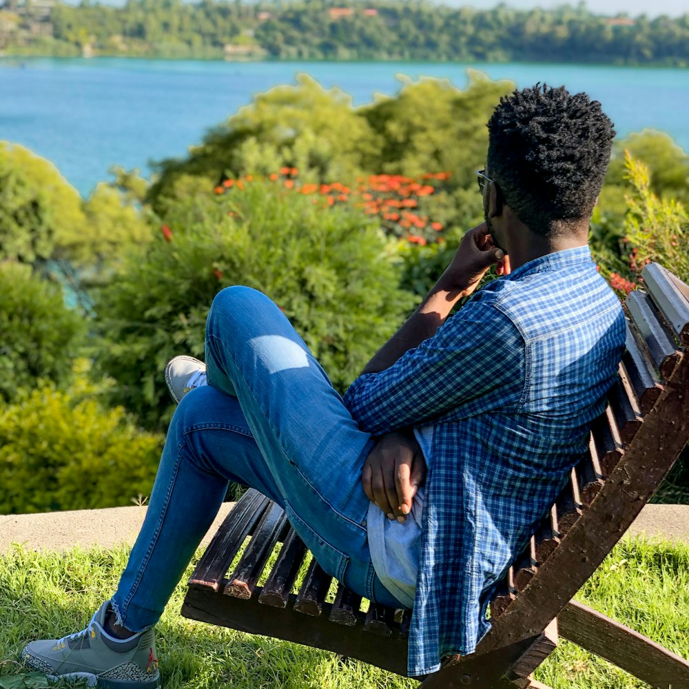 a man sitting on a bench talking on a cell phone