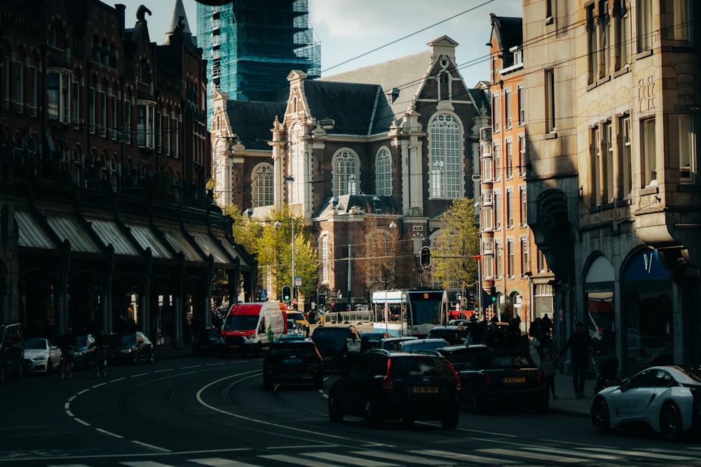 a city street filled with traffic next to tall buildings