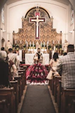 a woman in a red dress sitting in a church