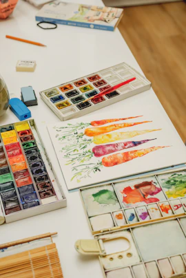 a table topped with lots of art supplies