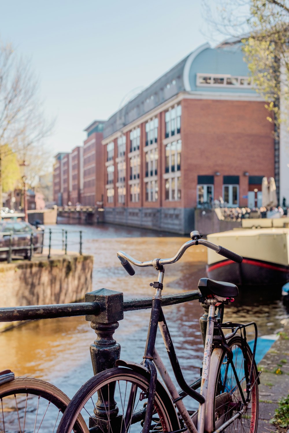 a bicycle parked next to a railing near a body of water