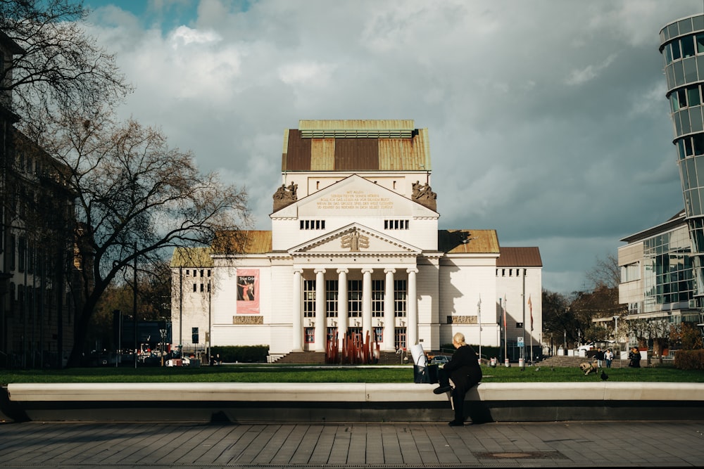 a person standing in front of a large building