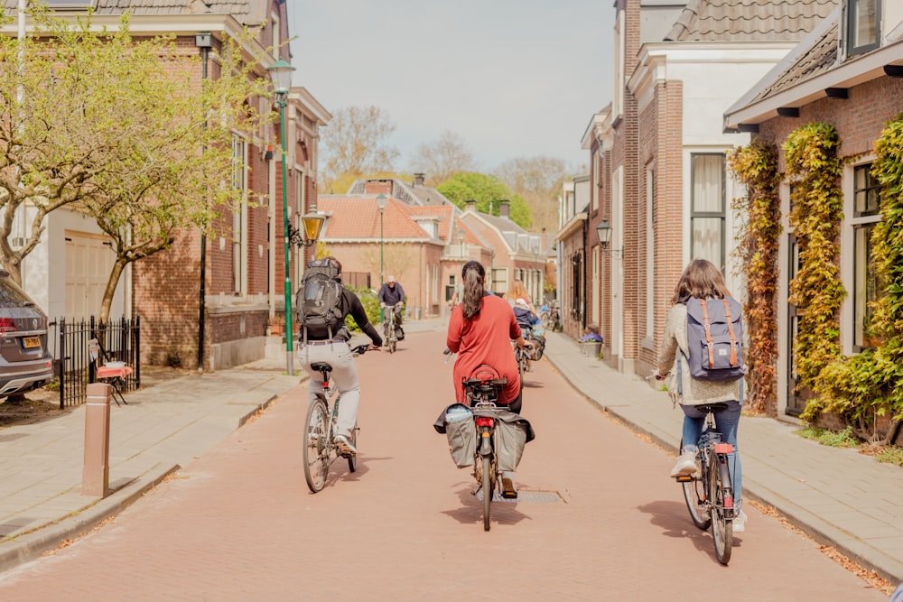 a couple of people riding bikes down a street