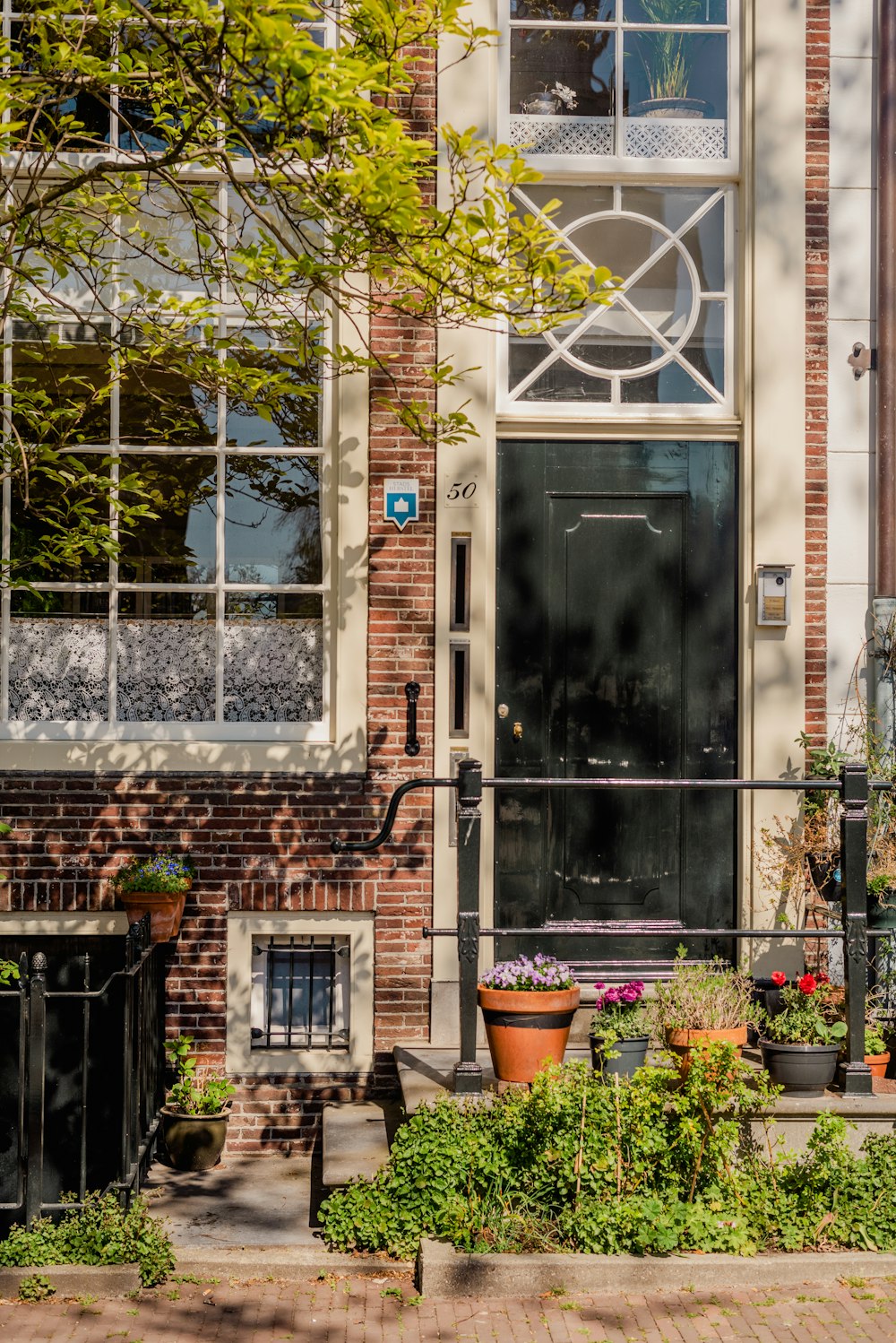 a brick building with a black door and window