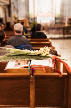 a group of people sitting in pews in a church