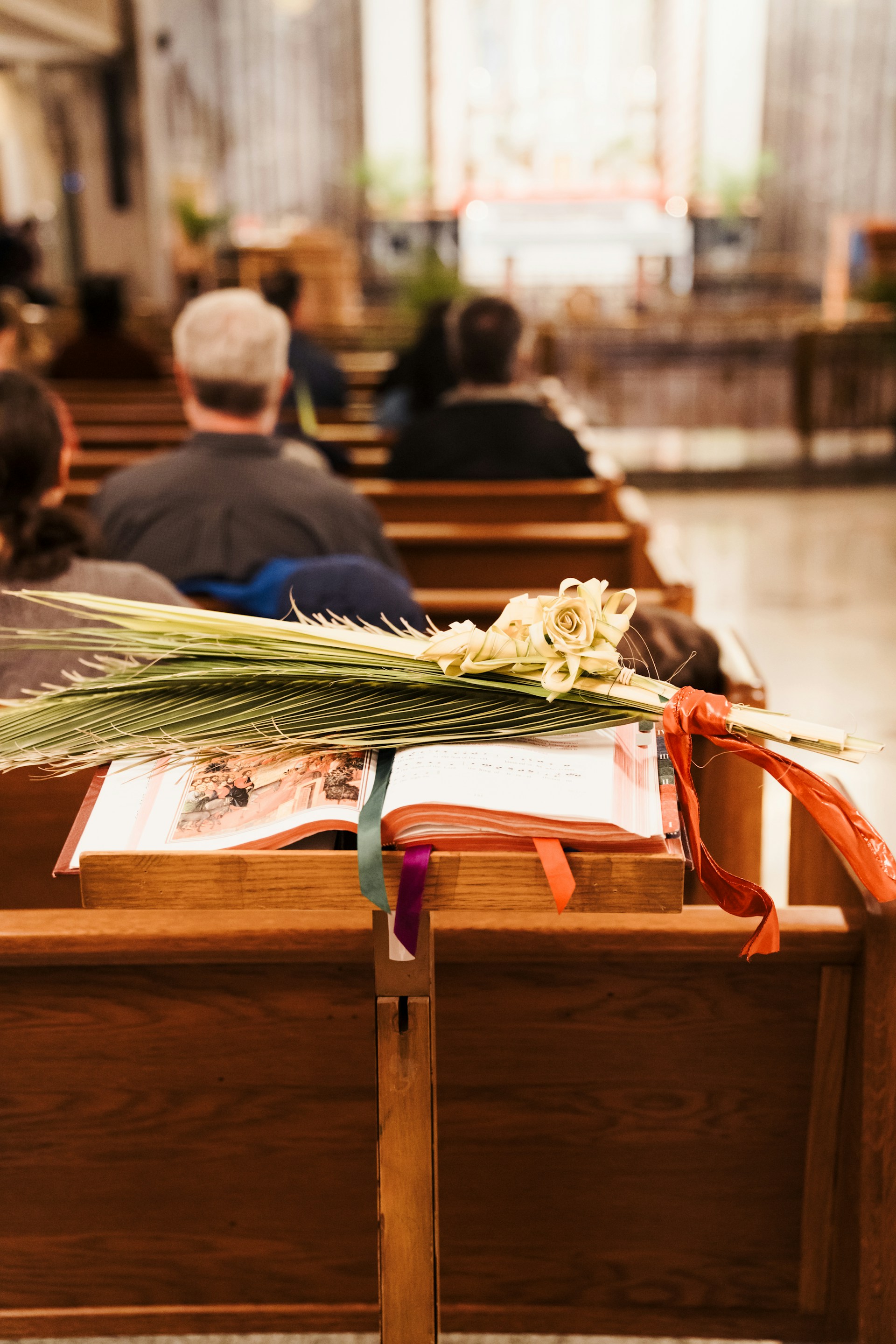 a group of people sitting in pews in a church