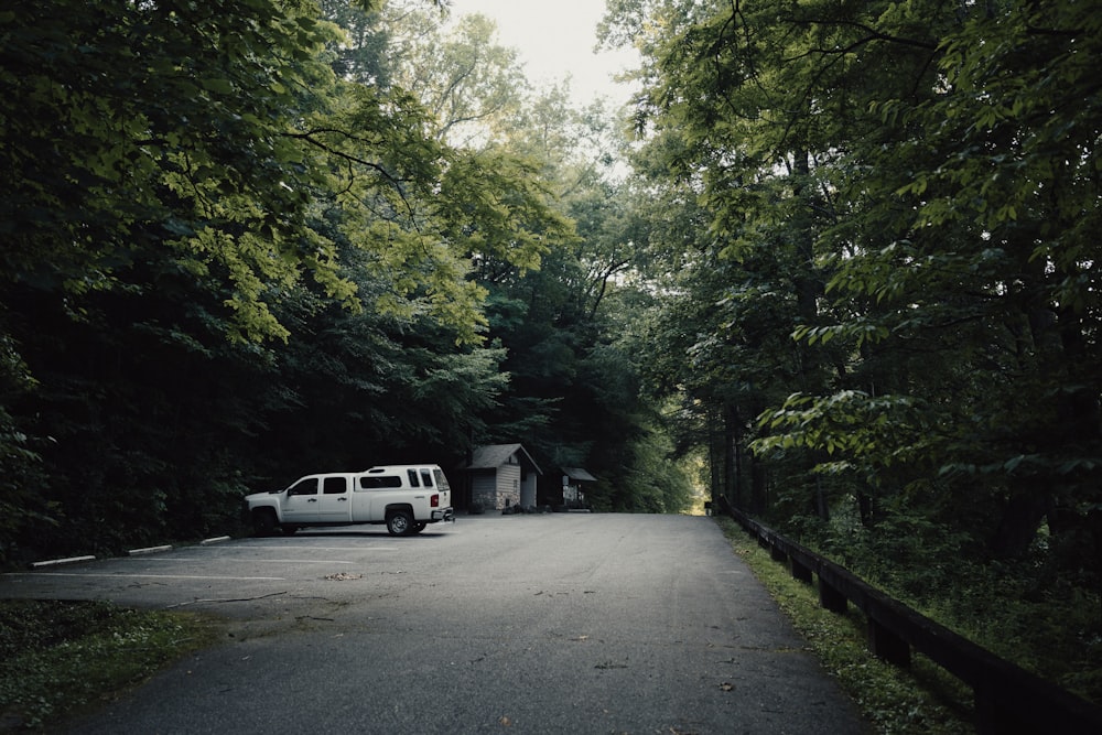 a white van is parked in the middle of the road