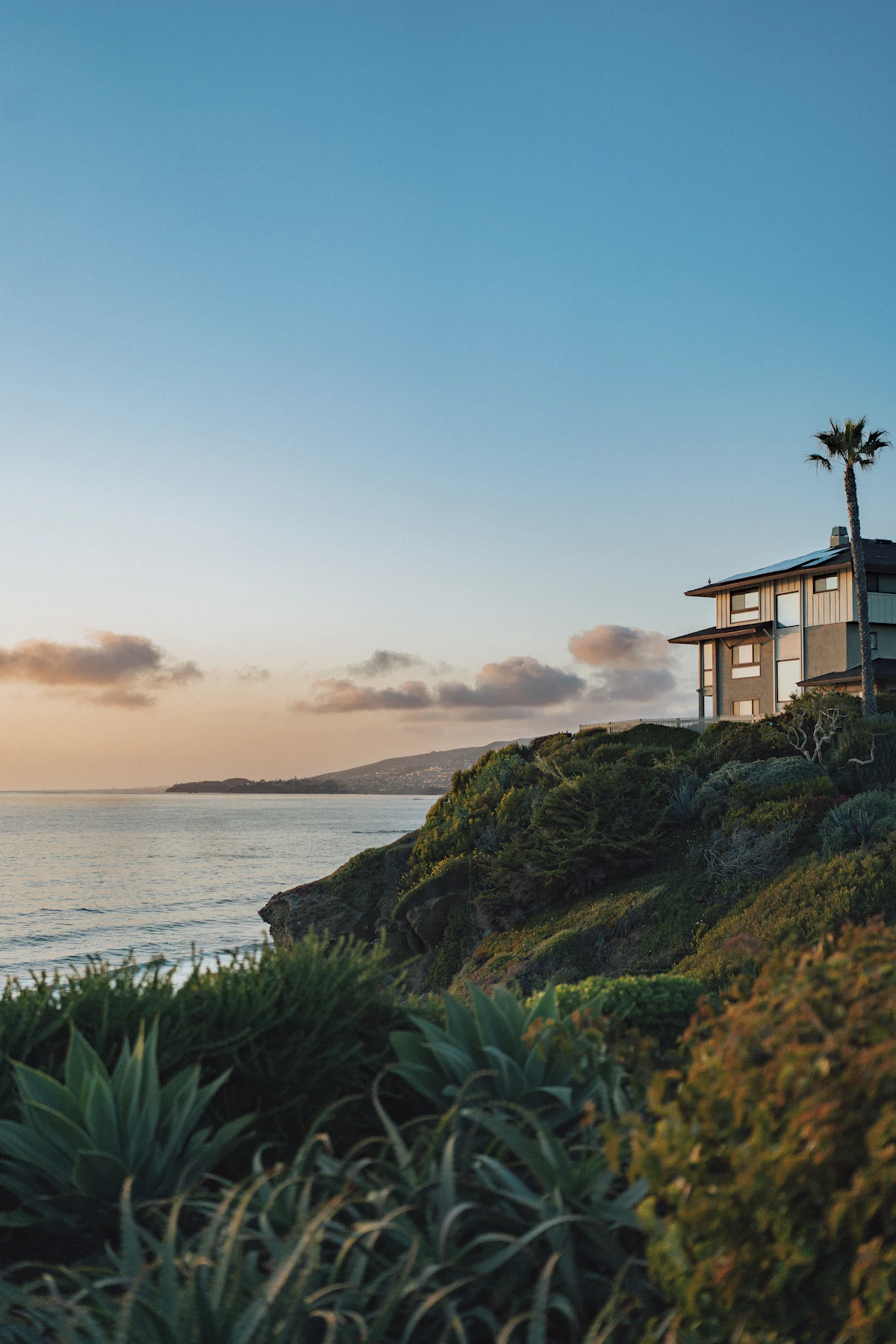 Beautiful hillside home overlooking the ocean at sunset