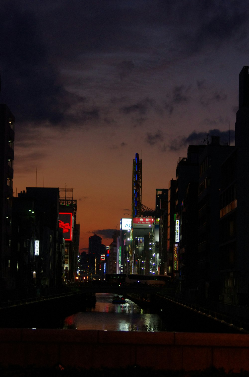 a city at night with a river running through it