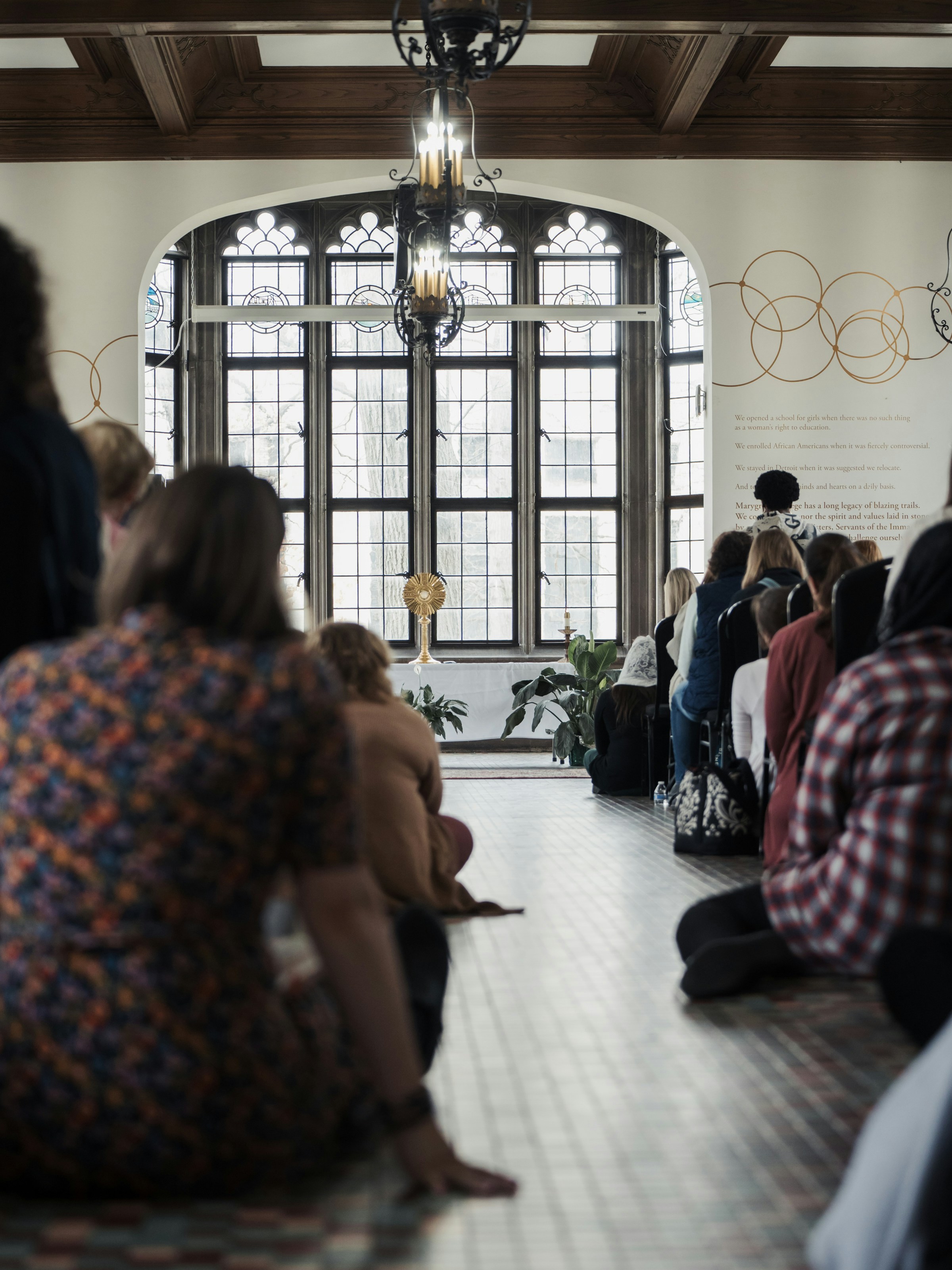 A group of people sitting in front of a window photo – Free Prayer ...