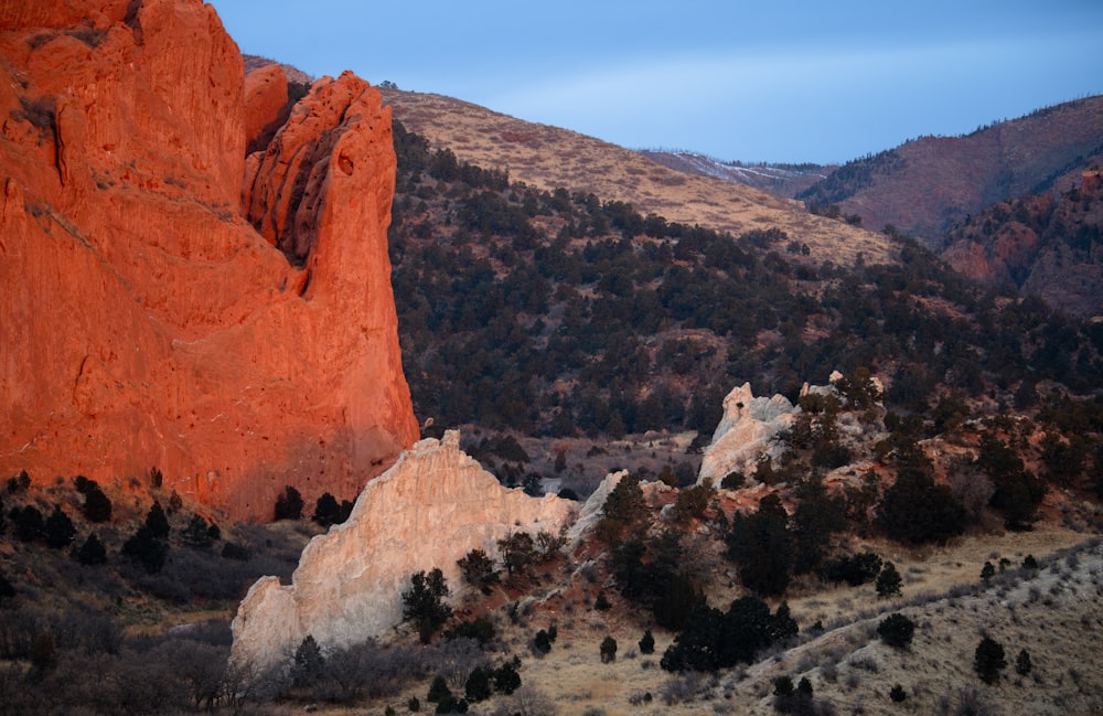 a large rock formation in the middle of a mountain range